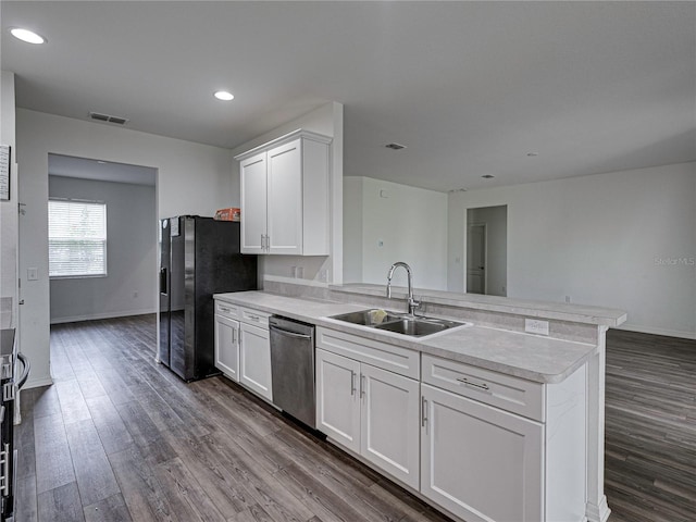 232 Samantha Ave, Auburndale, FL 33823 - kitchen featuring stainless steel appliances, a sink, a peninsula, light countertops, and white cabinetry