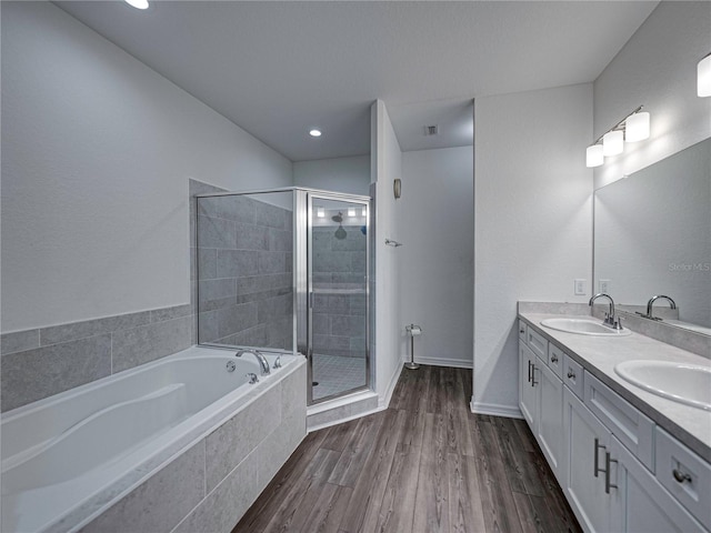 232 Samantha Ave, Auburndale, FL 33823 - full bath featuring a bath, double vanity, a stall shower, wood finished floors, and recessed lighting
