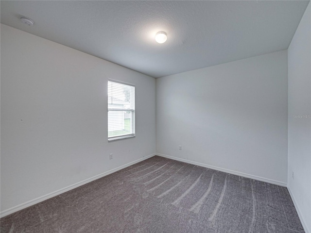 232 Samantha Ave, Auburndale, FL 33823 - unfurnished room featuring dark carpet, a smoke detector, and baseboards
