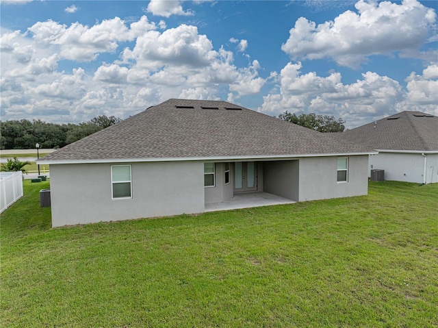 232 Samantha Ave, Auburndale, FL 33823 - back of property with roof with shingles, stucco siding, central air condition unit, and a patio