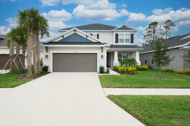 view of front of house featuring a garage and a front lawn