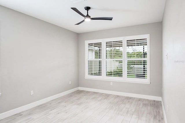 spare room featuring light wood-type flooring and ceiling fan