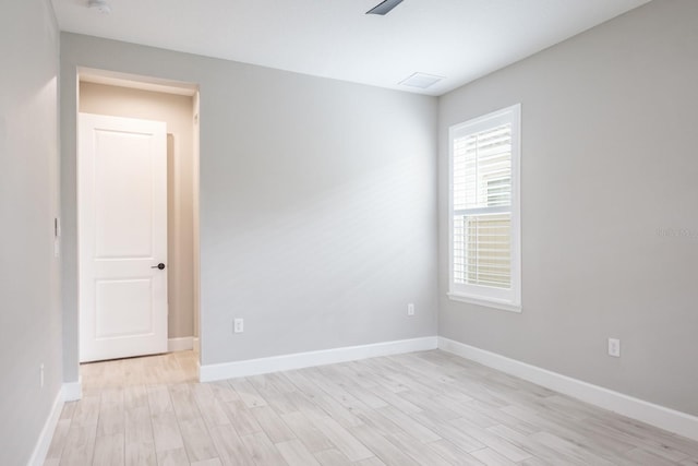 spare room featuring light hardwood / wood-style floors