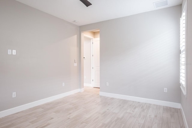 empty room with light hardwood / wood-style floors, a healthy amount of sunlight, and ceiling fan