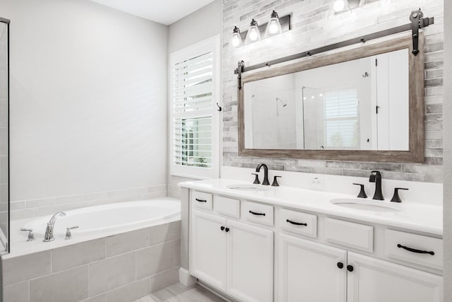 bathroom featuring decorative backsplash, vanity, and separate shower and tub