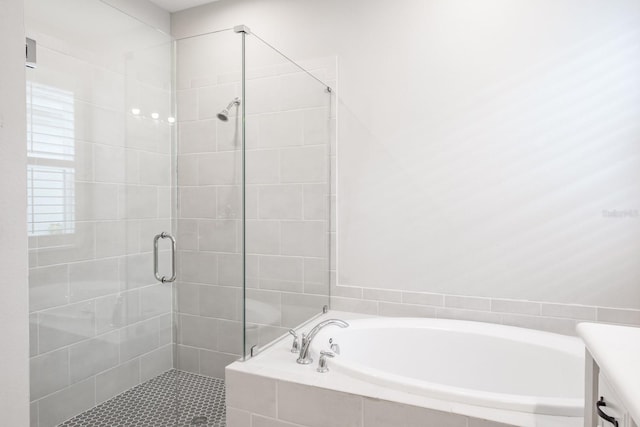 bathroom featuring plus walk in shower and vanity