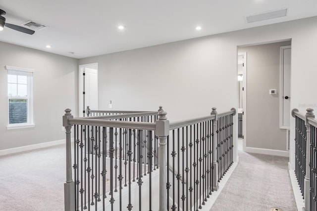 hallway with light colored carpet