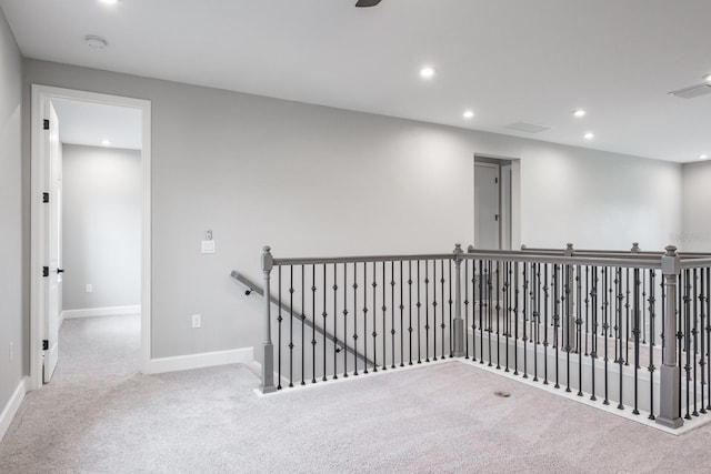 hallway featuring light carpet