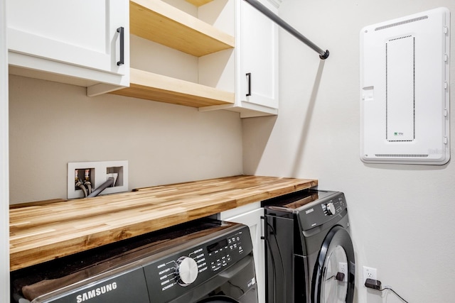 clothes washing area with hookup for a washing machine and cabinets