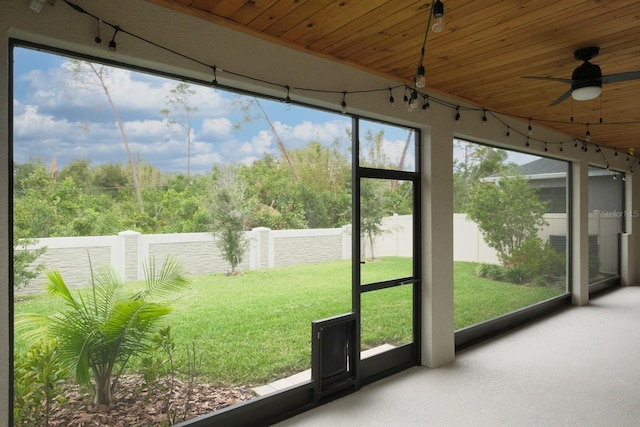 unfurnished sunroom featuring ceiling fan and wooden ceiling