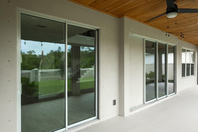 exterior space featuring wooden ceiling and ceiling fan