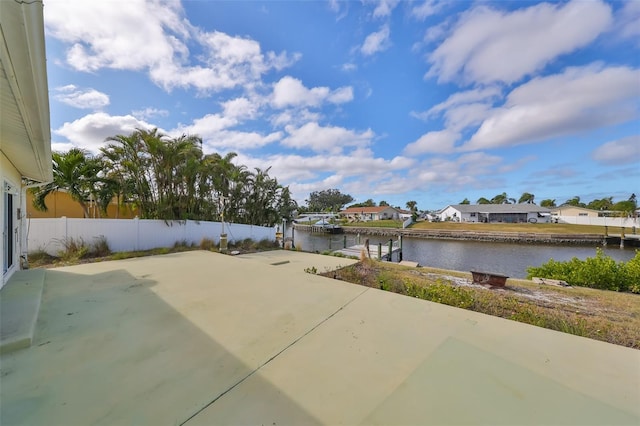 view of patio / terrace with a water view and a boat dock