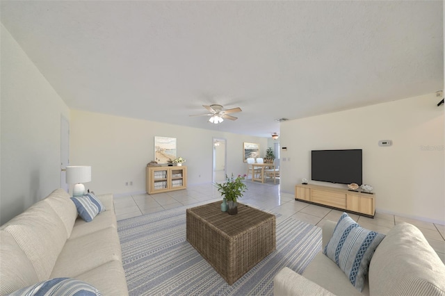 living room featuring light tile patterned floors and ceiling fan