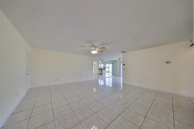 unfurnished room featuring french doors, a textured ceiling, ceiling fan, and light tile patterned flooring