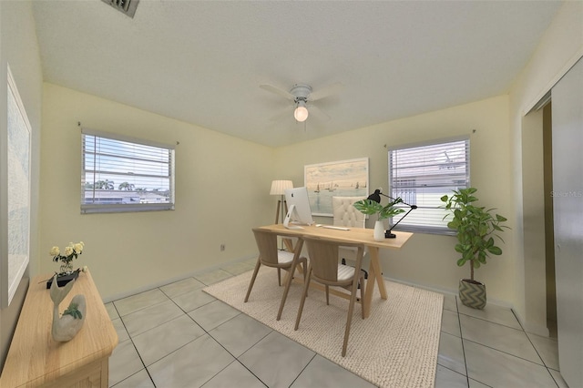 office featuring a wealth of natural light, light tile patterned flooring, and ceiling fan