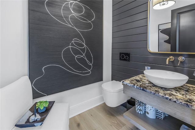 bathroom featuring sink, wood-type flooring, and toilet