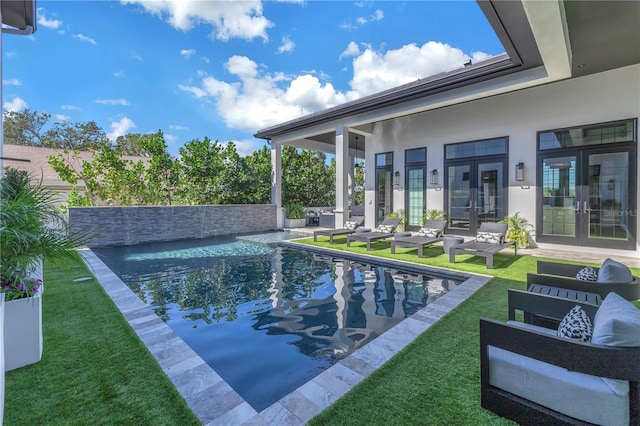 view of pool featuring french doors, an outdoor living space, a patio, and a yard