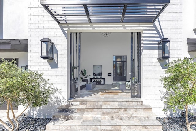 doorway to property featuring a pergola