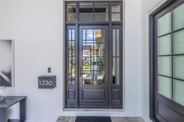 view of exterior entry with stucco siding