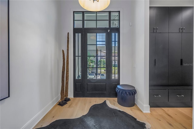 foyer entrance featuring wood finished floors and baseboards