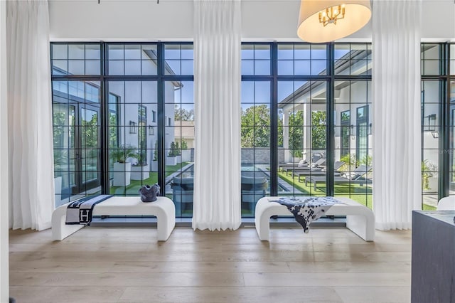 interior space featuring floor to ceiling windows, wood finished floors, and a healthy amount of sunlight