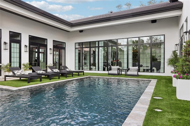 pool featuring a patio, french doors, and a yard