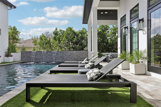 view of patio / terrace with a fenced in pool and french doors