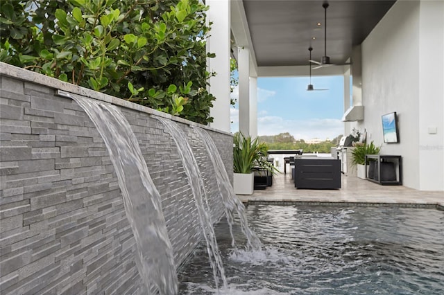 exterior space with a water view, an outdoor hangout area, and a ceiling fan