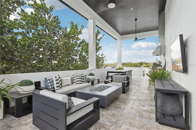 view of patio featuring an outdoor living space with a fire pit and ceiling fan