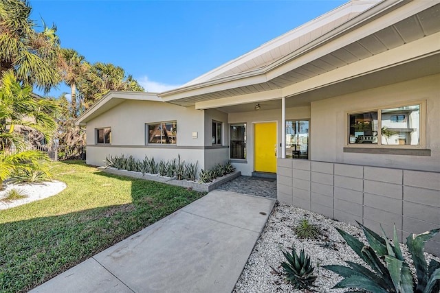 property entrance with a yard