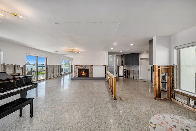 living room with a stone fireplace