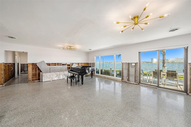 interior space with a water view and a notable chandelier