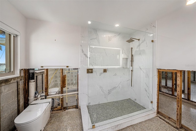 bathroom with toilet and a tile shower