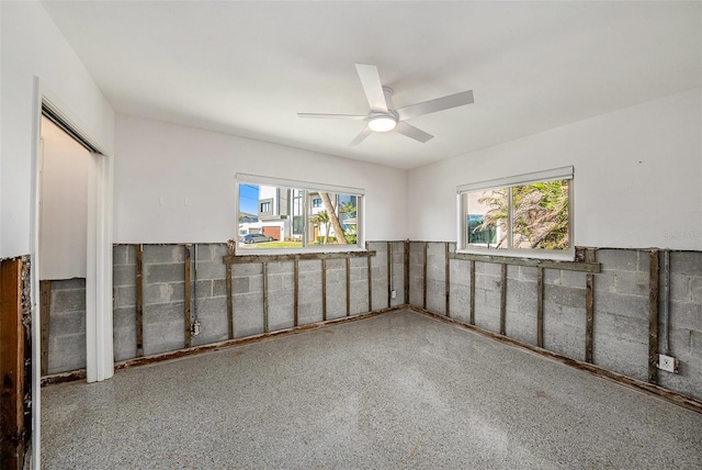 unfurnished room featuring ceiling fan and a healthy amount of sunlight