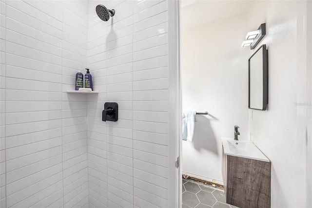 bathroom with vanity and tiled shower