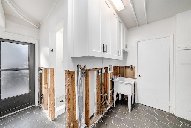 laundry room with dark tile patterned flooring