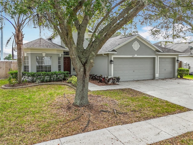 single story home with a front yard and a garage