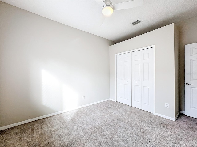 unfurnished bedroom featuring a closet, carpet, and ceiling fan