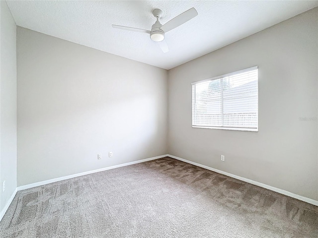 carpeted empty room featuring a textured ceiling and ceiling fan