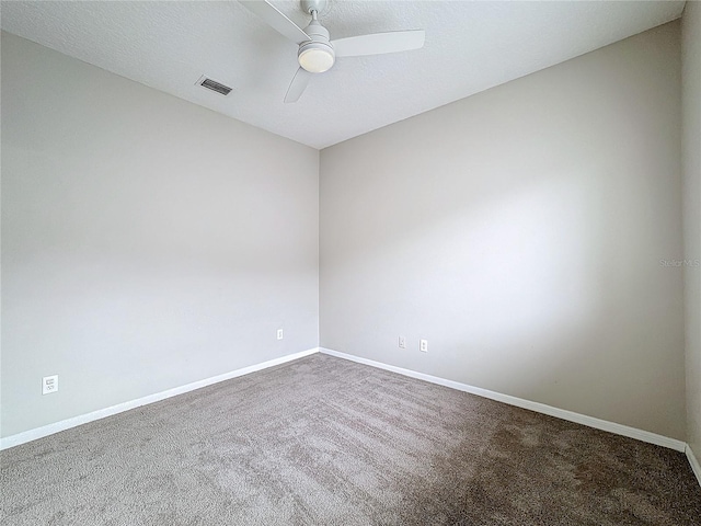 carpeted empty room featuring a textured ceiling and ceiling fan