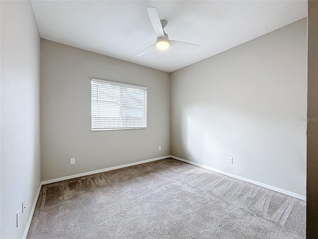 empty room with a textured ceiling, ceiling fan, and carpet floors