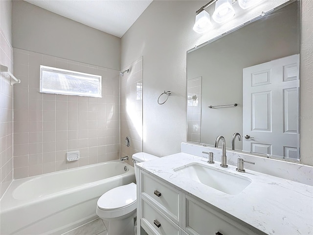 full bathroom with toilet, tiled shower / bath combo, vanity, and tile patterned flooring