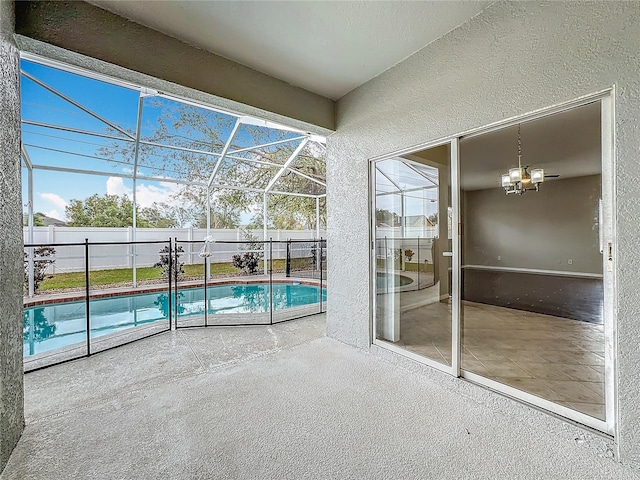 view of pool featuring glass enclosure and a patio area