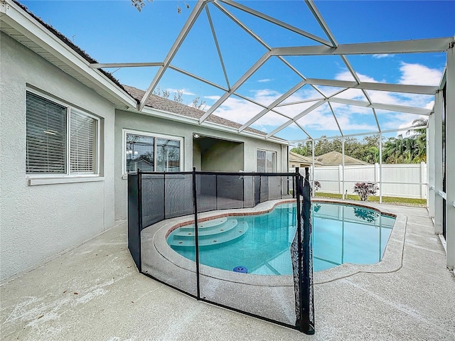 view of pool with a patio and a lanai