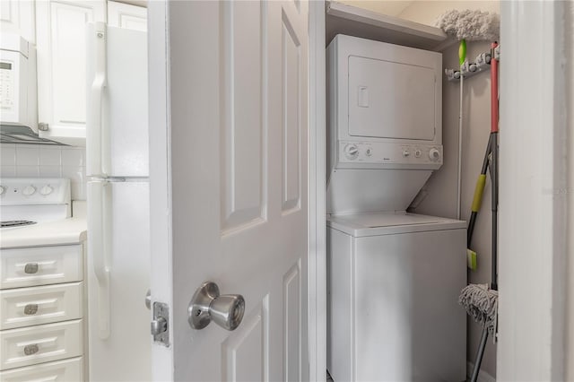 laundry area featuring stacked washer / drying machine