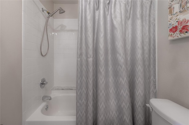 bathroom featuring shower / tub combo with curtain and toilet