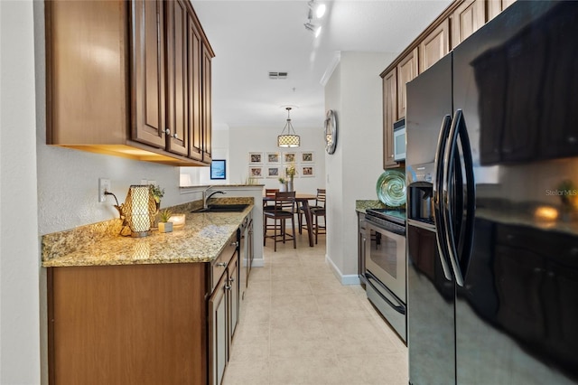 5000 Culbreath Key Way Unit 4-206, Tampa, FL 33611 - kitchen with black fridge, stainless steel electric stove, a sink, white microwave, and light stone counters