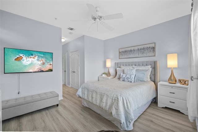 bedroom featuring a closet, light hardwood / wood-style floors, and ceiling fan