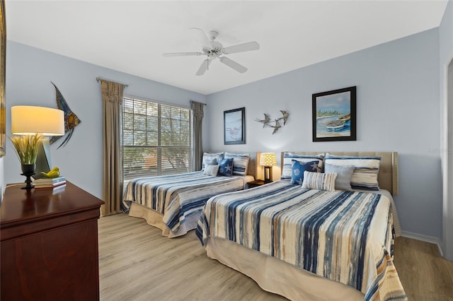 bedroom with light hardwood / wood-style floors and ceiling fan