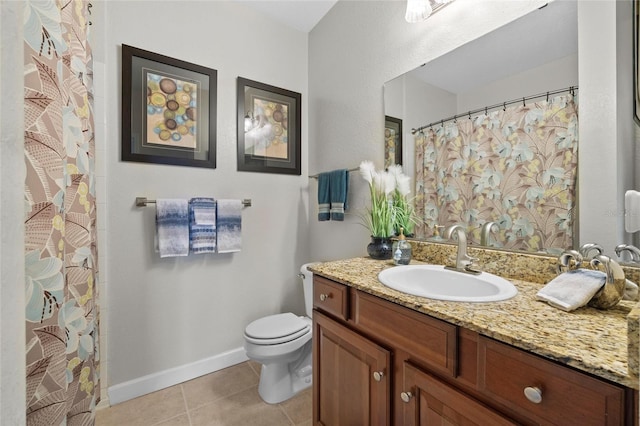 bathroom featuring vanity, tile patterned flooring, and toilet